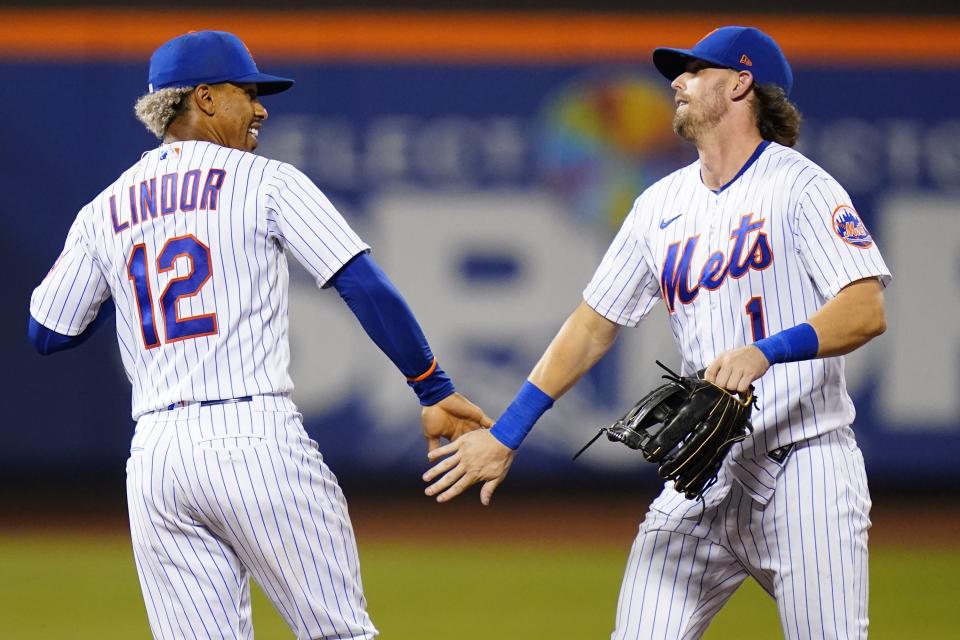 New York Mets' Francisco Lindor (12) celebrates with Jeff McNeil (1) after the team's baseball game against the Cincinnati Reds on Tuesday, Aug. 9, 2022, in New York. The Mets won 6-2. (AP Photo/Frank Franklin II)