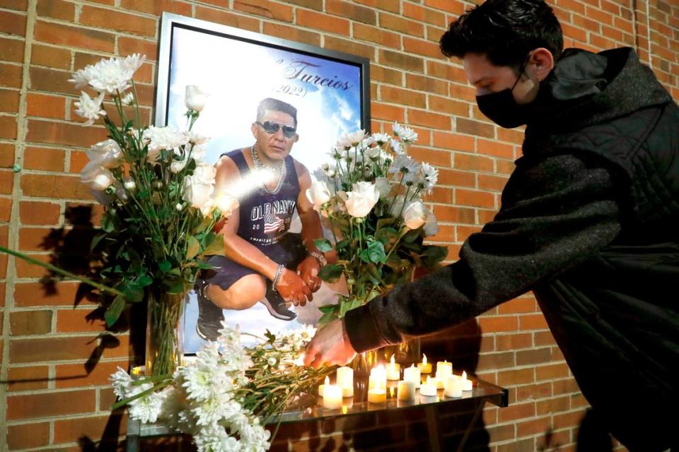 Attendees place flowers and candles at a memorial after a vigil for Daniel Turcios in Raleigh, N.C. January 14, 2022. Turcios was fatally shot by Raleigh police Tuesday afternoon after a crash on Interstate 440.