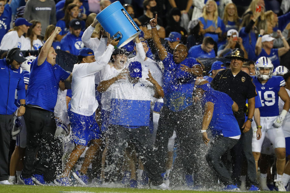 Sept. 11, 2021; Provo, Utah; Brigham Young Cougars head coach Kalani Sitake is dowsed in ice water as they celebrate during the final seconds of their game, beating the Utah Utes at LaVell Edwards Stadium. Jeffrey Swinger-USA TODAY Sports