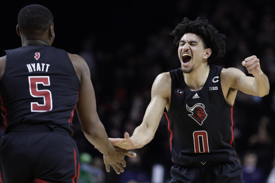 Rutgers guard Geo Baker (0) celebrates with Aundre Hyatt during the second half of the team's NCAA college basketball game against Illinois on Wednesday, Feb. 16, 2022, in Piscataway, N.J. (AP Photo/Adam Hunger)