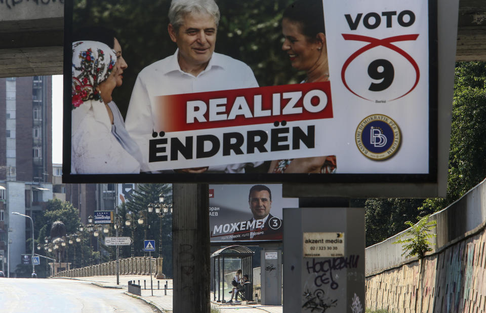 Electoral campaign poster of the leader of the ethnic Albanian party Democratic Union for Integrations (DUI) Ali Ahmeti, top, and the poster of the leader of the ruling Social Democrats Zoran Zaev, bottom, are displayed in a street in Skopje, North Macedonia on Saturday, July 11, 2020. North Macedonia holds its first parliamentary election under its new country name this week, with voters heading to the polls during an alarming spike of coronavirus cases in the small Balkan nation. (AP Photo/Boris Grdanoski)