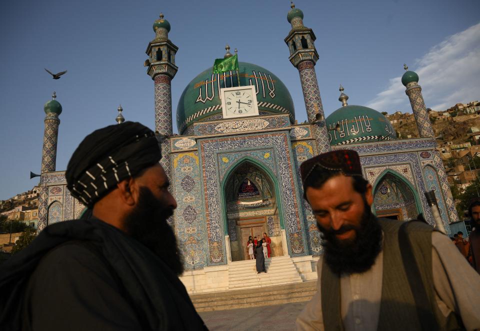 TOPSHOT - Taliban stand guard in front of the the Sakhi Shah-e Mardan Shrine and mosque in Kabul on july 24, 2022. - The shrine is visited mainly by Hazaras, a Shi?ite community. (Photo by Daniel LEAL / AFP) (Photo by DANIEL LEAL/AFP via Getty Images)