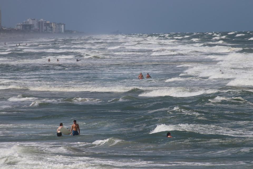 People take advantage of the last few hours to play in the surf off Daytona Beach as hurricane Matthew takes aim at Florida Tuesday October 4, 2016.