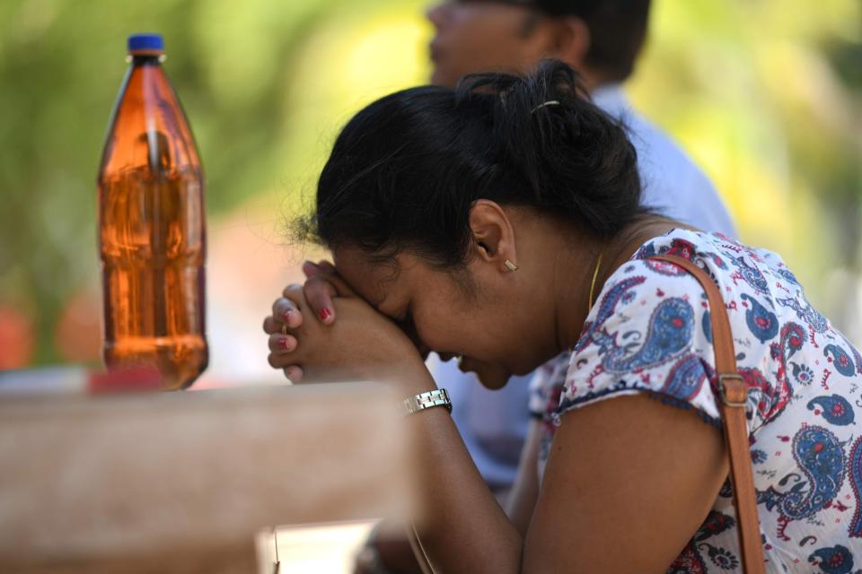 A woman prays at St. Sebastian's Church in Negombo a day after the blasts (AFP/Getty Images)