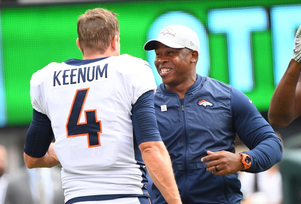 Oct 7, 2018; East Rutherford, NJ, USA; Then-Denver Broncos head coach Vance Joseph (right) talks to Denver Broncos quarterback Case Keenum (4) prior to their game at MetLife Stadium.