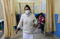 Shimray Wungreichon, 43, holds a syringe after administering a shot to an elderly patient, while being the only nurse on overnight shift in the emergency ward at the District Hospital in Ukhrul, in the northeastern Indian state of Manipur, Friday, Jan. 15, 2021. Wungreichon was among the first of many Indian health workers to be vaccinated on Saturday, opening a new chapter in the battle against the pandemic in the world's second hardest-hit country, which has been scarred profoundly by a virus that has killed more than 152,000 of its people. (AP Photo/Yirmiyan Arthur)