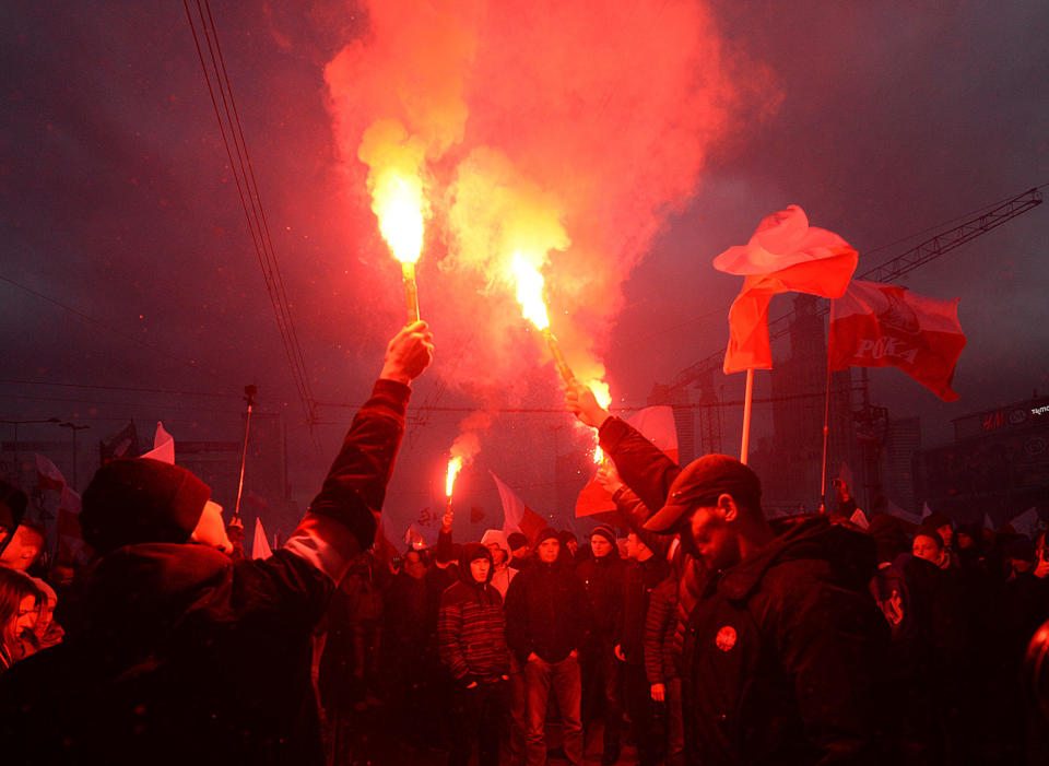 <p>Demonstrators burn flares and wave Polish flags during the annual march to commemorate Poland’s National Independence Day in Warsaw, Poland, Saturday, Nov. 11, 2017. (Photo: Czarek Sokolowski/AP) </p>