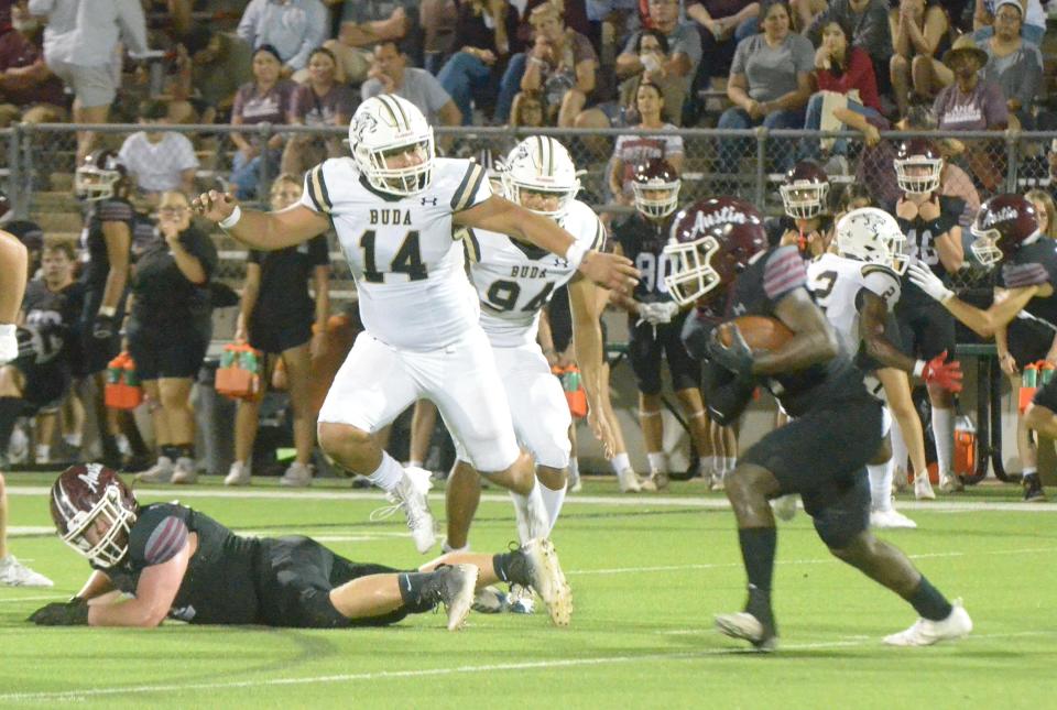 Johnson defensive lineman Michael Acosta leaps over an Austin High lineman while pursuing Maroons running back Bryson Batts in the second quarter of the Jaguars' 20-19 win Thursday night at House Park. The win kept Johnson in the hunt for a District 26-6A playoff spot.