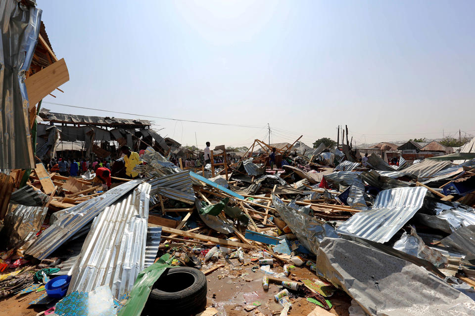 <p>Traders attempt to salvage their goods at the scene of a suicide bomb explosion at the Wadajir market in Madina district of Somalia’s capital Mogadishu, Feb. 19, 2017. (Photo: Feisal Omar/Reuters) </p>