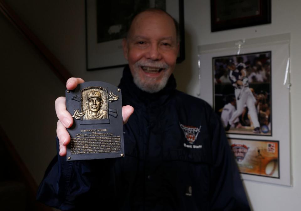 Mike "Tiger" Price shows off a small replica of Detroit Tigers Jack Morris' Hall of Fame plaque, which is part of his extensive Detroit Tigers collection in his basement on April 6, 2022. Price is a Tigers super fan.