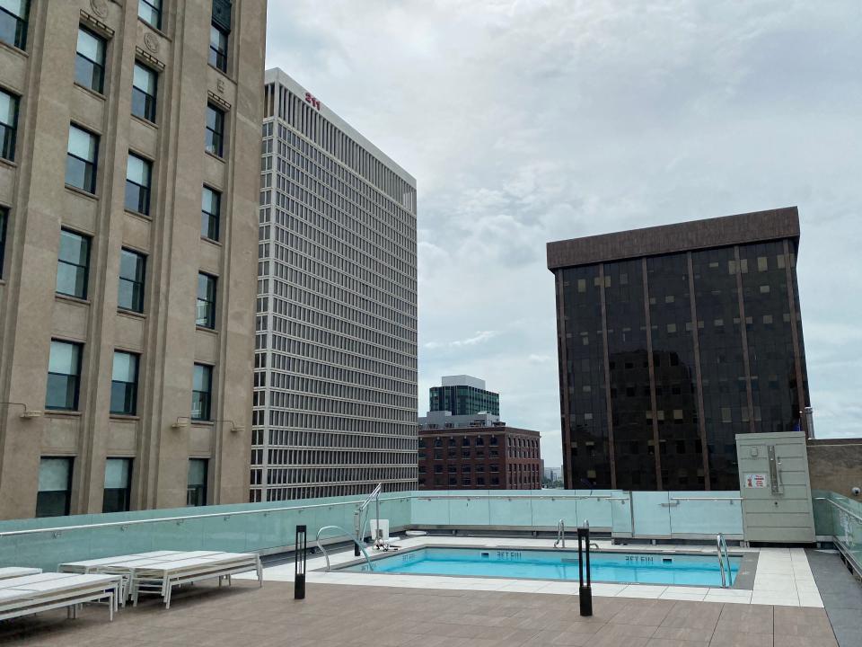 The pool at The Press/321 outside on the rooftop with buildings surrounding it