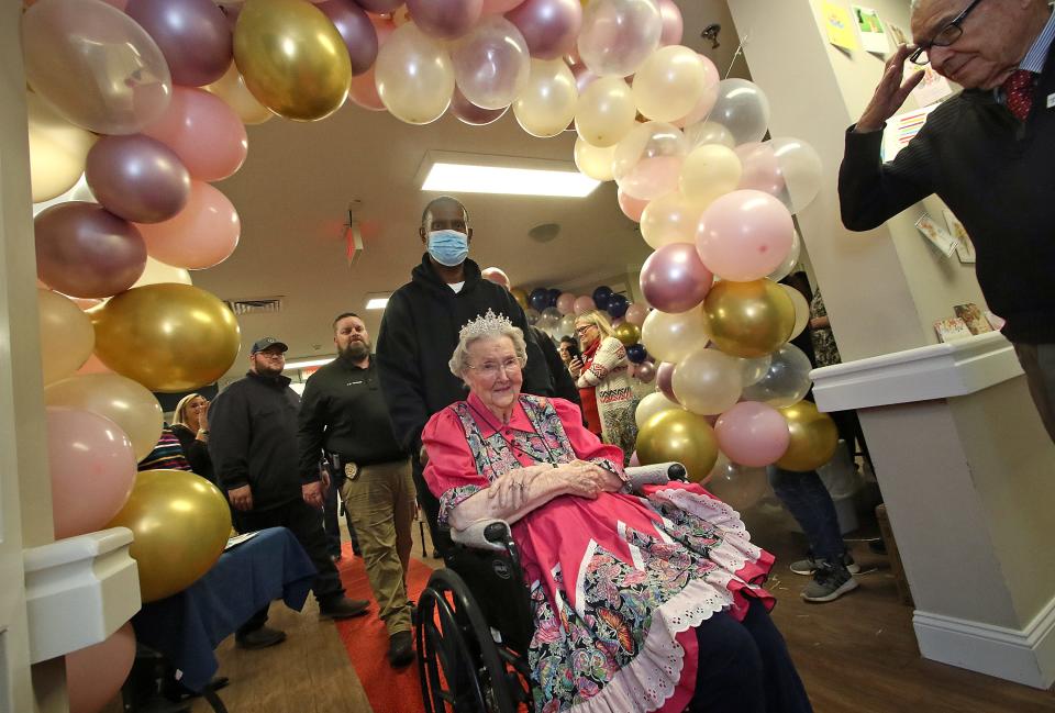 Lorene Summey is escorted to her 105th birthday party Friday evening, Nov. 18, 2022, at Somerset Court of Cherryville.