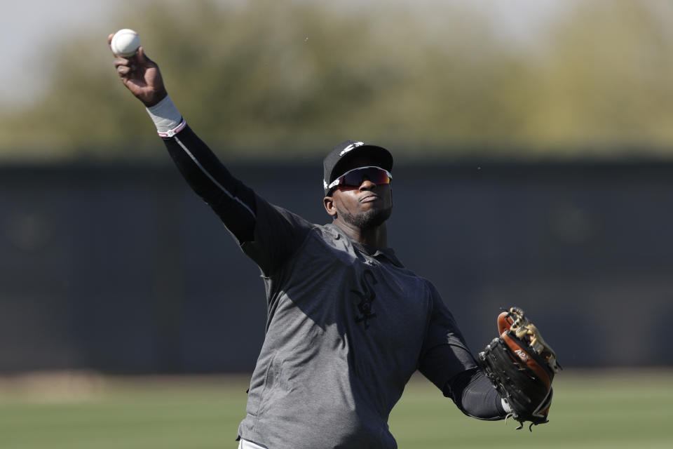 FILE - In this Monday, Feb. 17, 2020, file photo, Chicago White Sox center fielder Luis Robert throws the ball during spring training baseball in Phoenix. The 22-year-old Robert joins a formidable White Sox lineup after agreeing to a $50 million, six-year contract in January. (AP Photo/Gregory Bull, File)