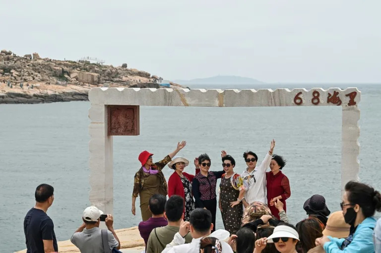 On the verdant island of Pingtan, in the eastern Chinese province of Fujian, hundreds of tourists gather at a seaside site which is the closest place in mainland China to Taiwan (Hector RETAMAL)