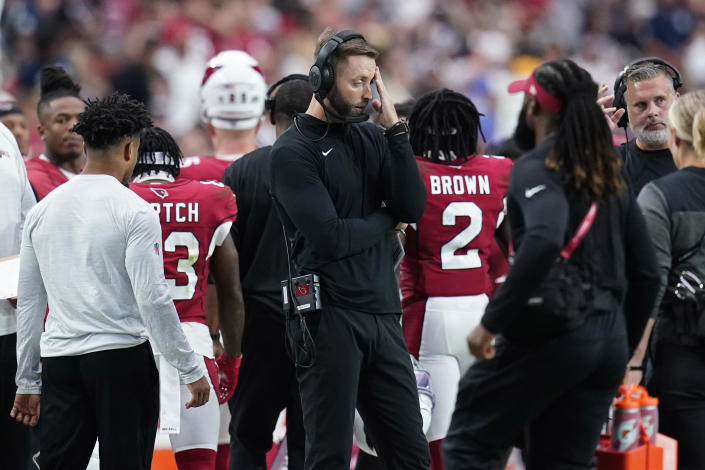 Arizona Cardinals head coach Kliff Kingsbury, center, stands on the sidelines during the second half of an NFL football game against the Los Angeles Rams, Sunday, Sept. 25, 2022, in Glendale, Ariz. (AP Photo/Ross D. Franklin)