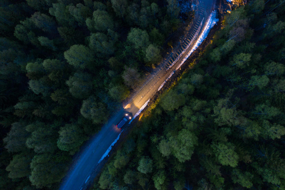 Car driving on a country road in the evening