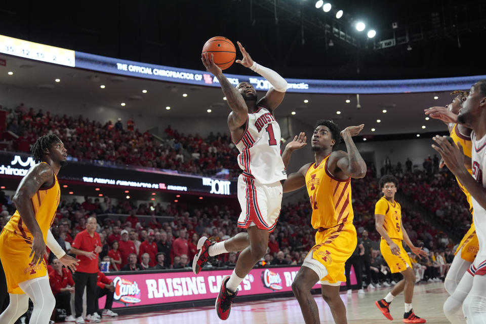 Houston's Jamal Shead (1) goes up for a shot as Iowa State's Hason Ward (24) defends during the second half of an NCAA college basketball game Monday, Feb. 19, 2024, in Houston. Houston won 73-65. (AP Photo/David J. Phillip)