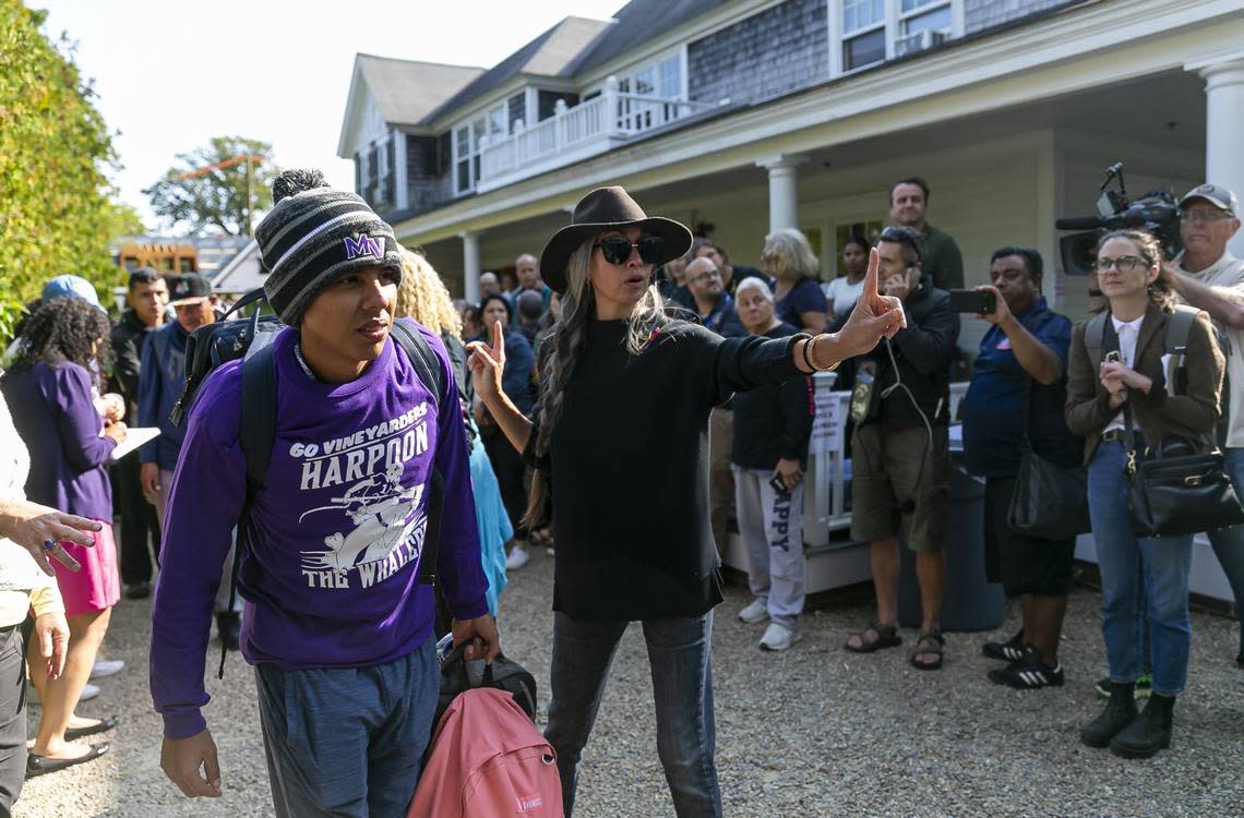 A Venezuelan migrant is led onto a bus at St. Andrews Episcopal Church on Friday, Sept. 16, 2022, in Edgartown, Massachusetts, on the island of Martha’s Vineyard. A group of 48 migrants was flown to the island from Texas earlier this week, leaving them stranded. They are now being transferred to a military base in Cape Cod.