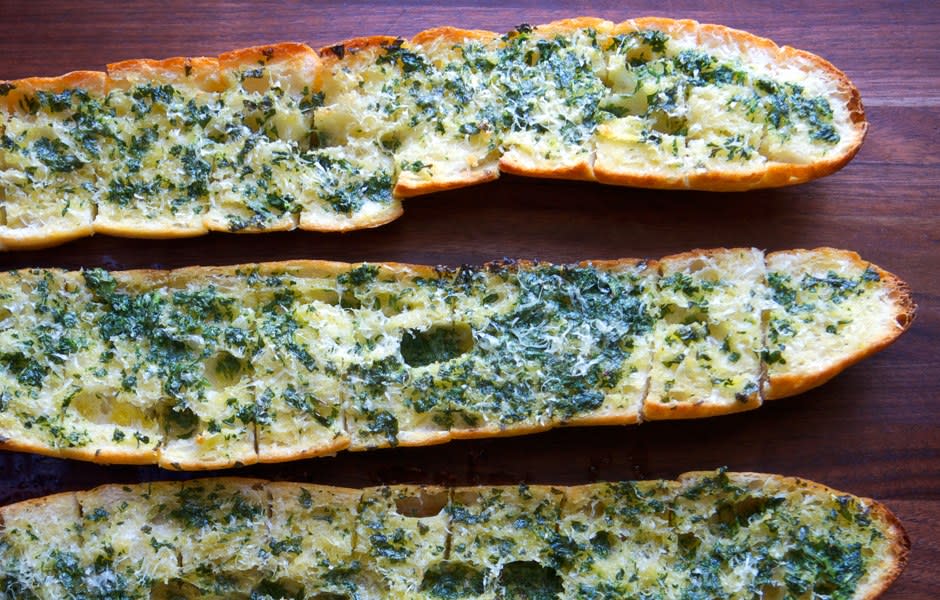 You can cut and butter the bread well in advance, but don’t bake it until guests arrive. This is part of BA's Best, a collection of our essential recipes. <a rel="nofollow noopener" href="https://www.bonappetit.com/recipe/old-school-garlic-bread?mbid=synd_yahoo_rss" target="_blank" data-ylk="slk:See recipe.;elm:context_link;itc:0;sec:content-canvas" class="link ">See recipe.</a>