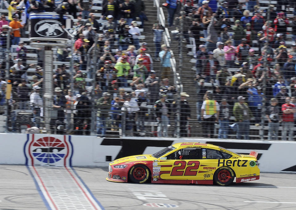 Joey Logano crosses the finish line to win the NASCAR Sprint Cup series auto race at Texas Motor Speedway, Monday, April 7, 2014, in Fort Worth, Texas. (AP Photo/Larry Papke)
