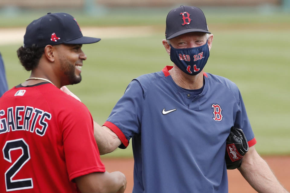 Boston Red Sox's Xander Bogaerts laughs with interim manager Ron Roenicke, right, during baseball training camp at Fenway Park, Monday, July 6, 2020, in Boston. (AP Photo/Elise Amendola)