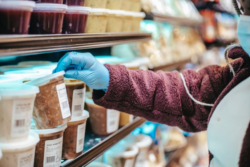 Woman reading the nutrition facts on a food container