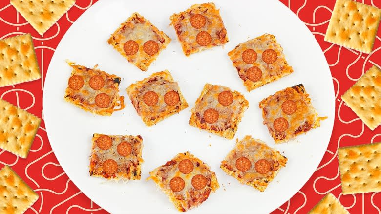 Saltine pizzas on white plate