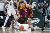 Michigan State's Max Christie, left, loses the ball as he is fouled by Minnesota's Payton Willis (0) during the first half of an NCAA college basketball game, Wednesday, Jan. 12, 2022, in East Lansing, Mich. (AP Photo/Al Goldis)