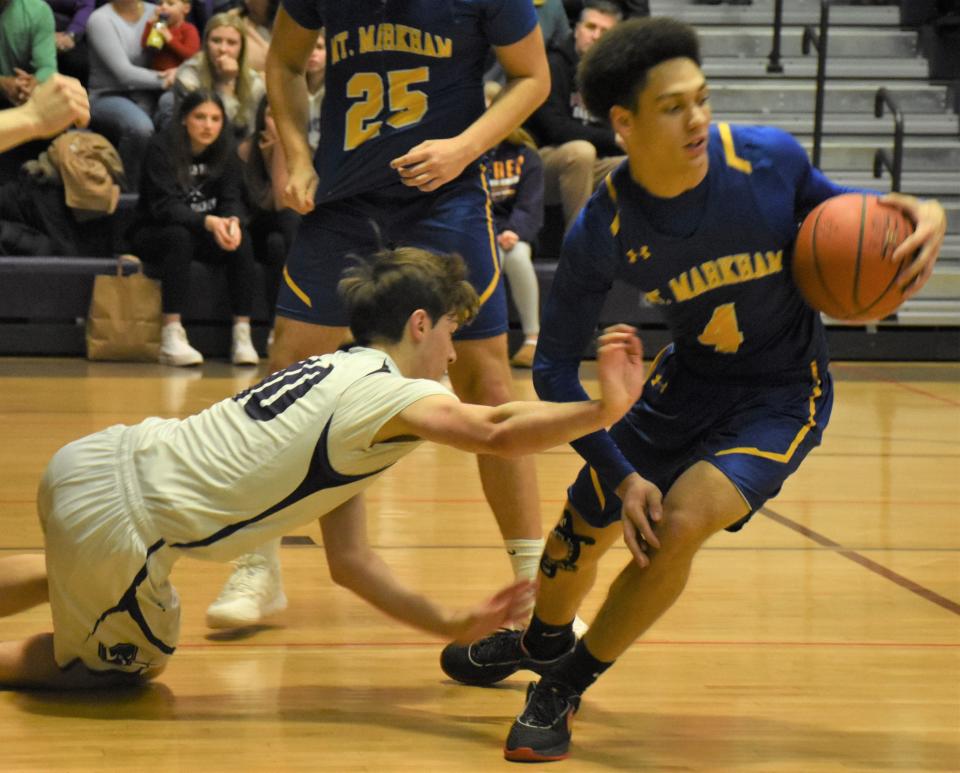 Mt. Markham Mustang Will Lunny (4) turns up the court after grabbing a loose ball away from Little Falls Mountie Brayton Langdon (left) during the first half of a Section III quarterfinal Wednesday, Feb. 2, 2023, in Little Falls, New York.