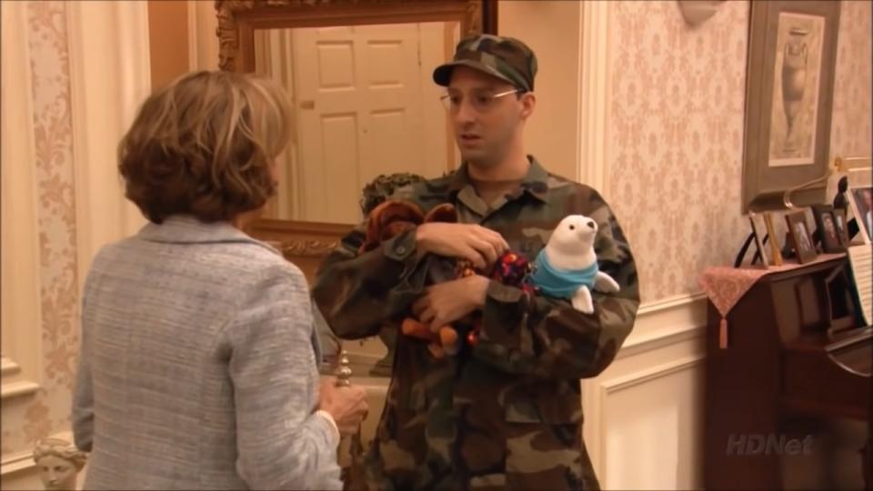 Buster talking with Lucille while holding plush toys in "Arrested Development"