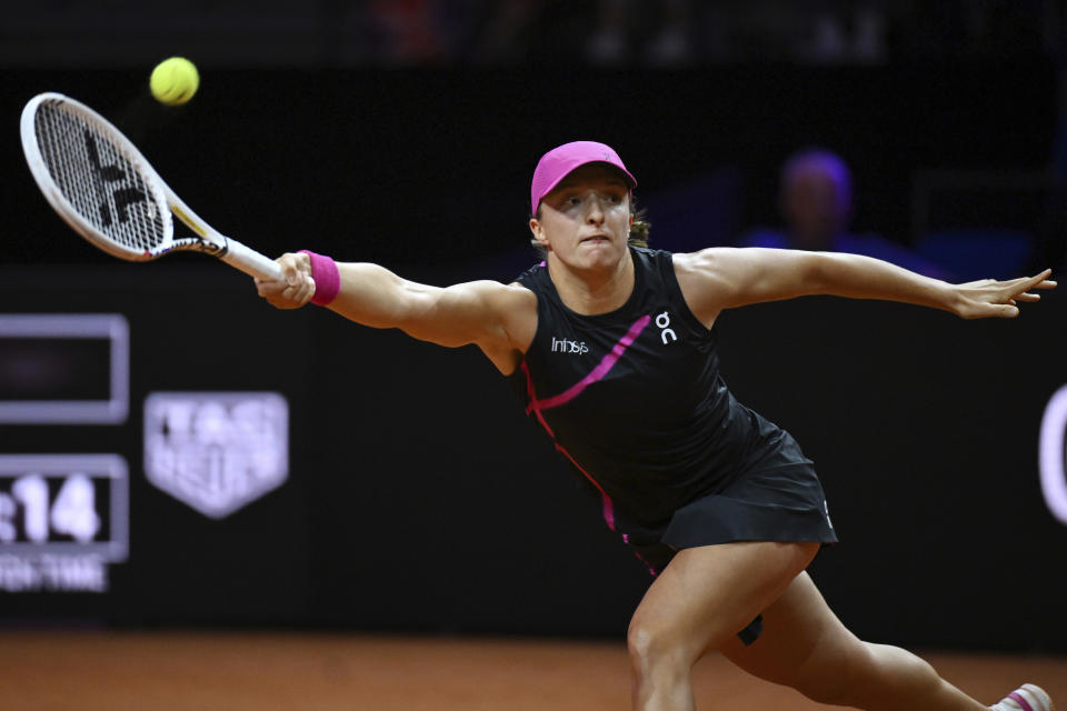 Poland's Iga Swiatek plays Britain's Emma Raducanu during her quarterfinals tennis match at the WTA Tour in Stuttgart, Germany, Friday April 19, 2024. (Marijan Murat/dpa via AP)