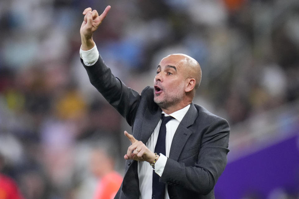 Manchester City's head coach Pep Guardiola gestures during the Soccer Club World Cup final match between Manchester City FC and Fluminense FC at King Abdullah Sports City Stadium in Jeddah, Saudi Arabia, Friday, Dec. 22, 2023. (AP Photo/Manu Fernandez)