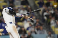 Los Angeles Dodgers' Shohei Ohtani breaks his bat as he lines out to third base during the fourth inning of the team's baseball game against the San Diego Padres on Saturday, April 13, 2024, in Los Angeles. (AP Photo/Marcio Jose Sanchez)