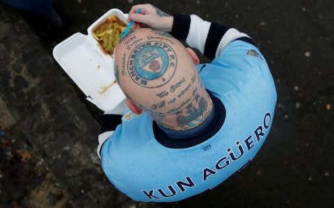 A Manchester City fan with a Manchester City tattoo on his head outside the stadium before the match - Credit: Action Images via Reuters/Carl Recine