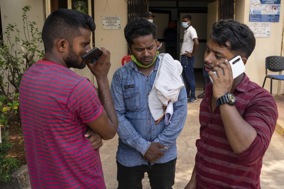 Usman Karim, center, whose brother in law died in Friday's train accident waits with his friends to collect the body at the All India Institute of Medical Sciences hospital in Bhubaneswar in the eastern state of Orissa, India, Monday, June 5, 2023. Families of the victims of India’s deadliest train crash in decades filled the hospital on Monday to identify and collect bodies of relatives, as railway officials recommended the country’s premier criminal investigating agency to probe the crash that killed 275 people. (AP Photo/Rafiq Maqbool)