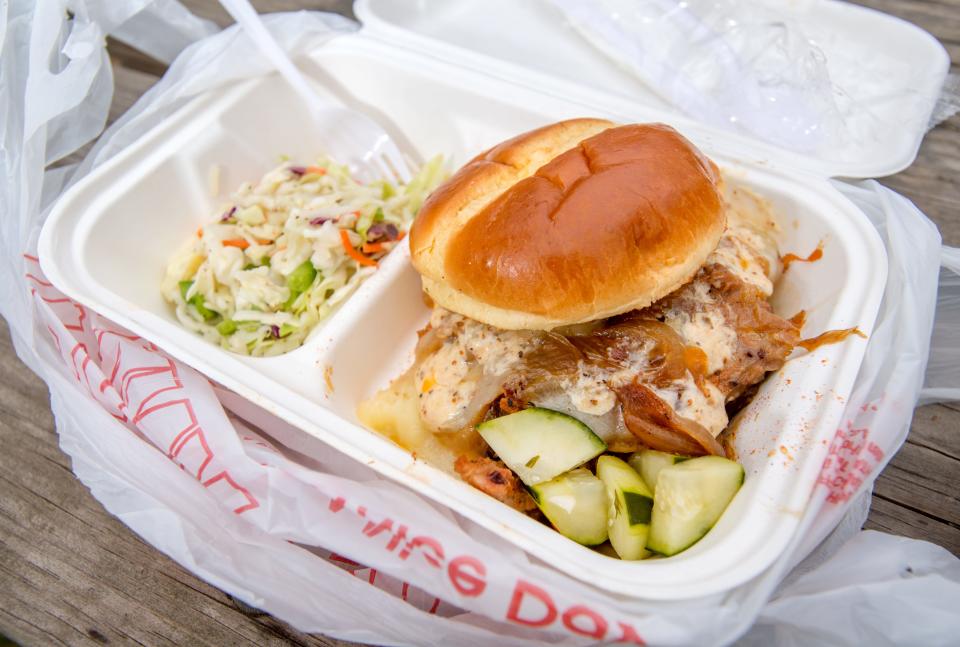 The prime brisket sandwich from Dac’s Smokehouse, 1200 W. Main St. in Campustown, is composed of the eatery’s prime barbecue brisket covered with white cheddar, caramelized onions, and smoked garlic aioli on a brioche bun with pickles on the side. A variety of side dishes, like Carolina coleslaw, are available.