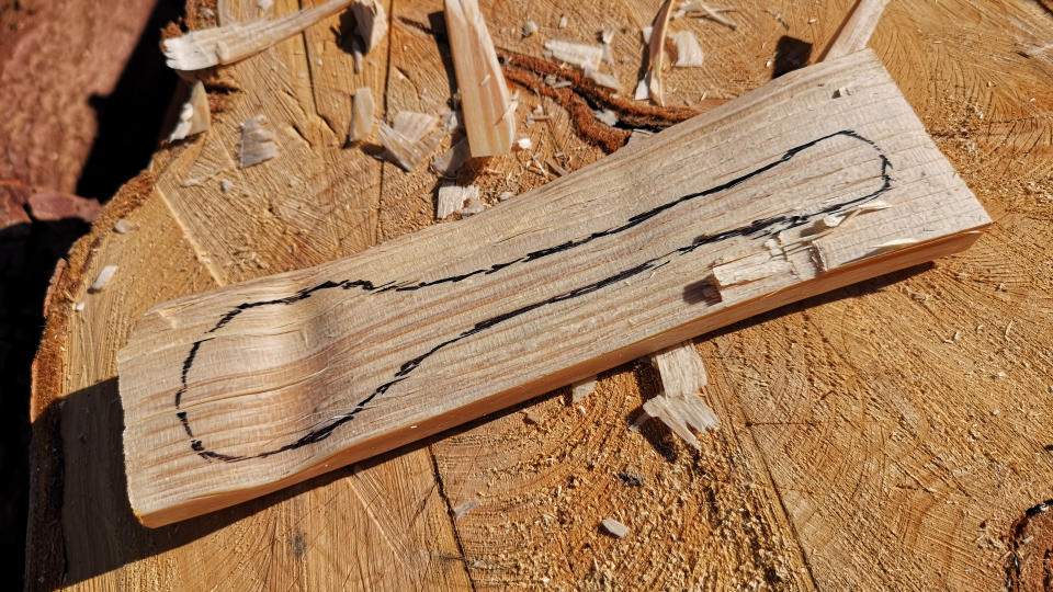 A block of wood with a spoon drawn on it