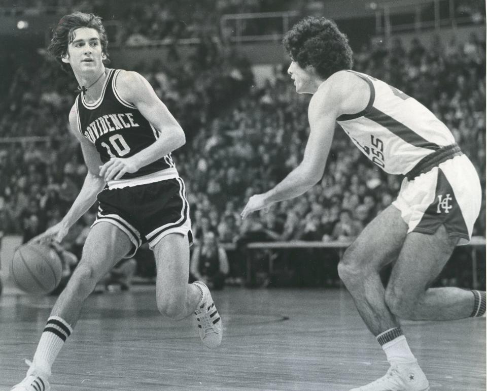 Providence's Joe Hassett, left, is defended by Holy Cross' Michael Vicens in a 1975 game.