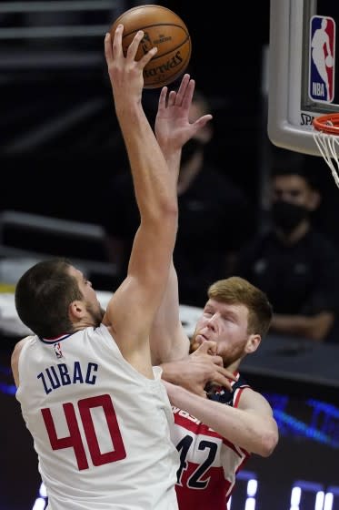 Clippers center Ivica Zubac shoots over Washington forward Davis Bertans on Feb. 23 at Staples Center.