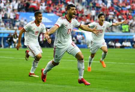 Soccer Football - World Cup - Group B - Morocco vs Iran - Saint Petersburg Stadium, Saint Petersburg, Russia - June 15, 2018 Iran's Mehdi Taremi, Majid Hosseini and Sardar Azmoun celebrate their first goal REUTERS/Dylan Martinez