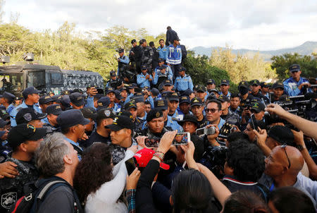 Police officers speak to the media outside the headquarters of Honduras' elite police force, after an agreement with the government not to crack down on demonstrators in the marches over a contested presidential election, according to local media, in Tegucigalpa, Honduras December 5, 2017. REUTERS/Henry Romero