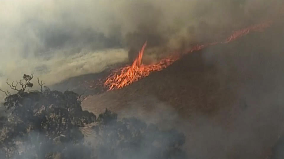 In this aerial image made from video, fire burning in Birdwood, South Australia state, Wednesday, Dec. 25, 2019. South Australia state, which last week had dozens of homes destroyed after wildfires flared in catastrophic conditions, is bracing for a return of extreme temperatures, with Adelaide, the state capital, expected to reach 41 C (106 F) on Saturday.(Australian Broadcasting Corporation, Channel 7, Channel 9 via AP)