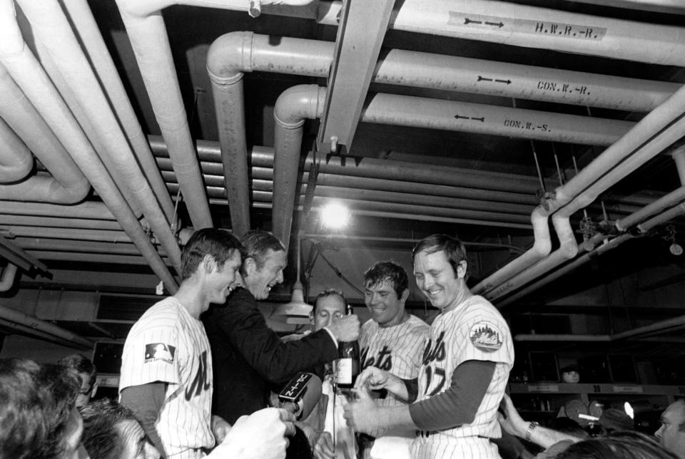 New York City Mayor John Lindsay celebrates with the New York Mets their World Series victory over the Baltimore Orioles in dressing room at New York's Shea Stadium, Thursday, Oct. 16, 1969. Standing from left are, Bud Harrelson; Mayor Lindsay; annnouncer Lindsay Nelson; Ron Swoboda (4); and Rod Gasper (17). (AP Photo)