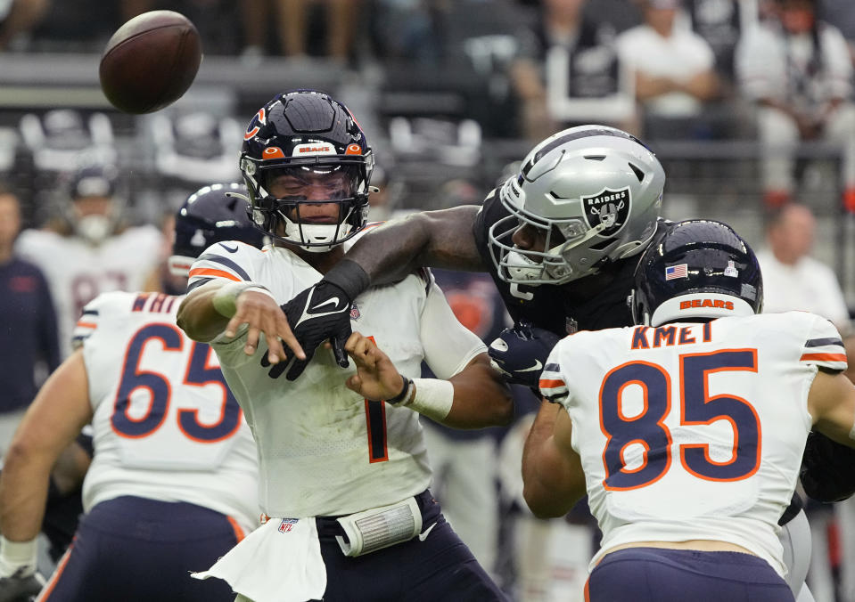 Las Vegas Raiders defensive end Yannick Ngakoue (91) breaks up a pass attempt by Chicago Bears quarterback Justin Fields (1) during the first half of an NFL football game, Sunday, Oct. 10, 2021, in Las Vegas. (AP Photo/Rick Scuteri)