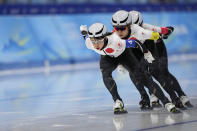 Team Japan, led by Nana Takagi, with Miho Takagi center and Ayano Sato, competes during the speedskating women's team pursuit finals at the 2022 Winter Olympics, Tuesday, Feb. 15, 2022, in Beijing. (AP Photo/Sue Ogrocki)