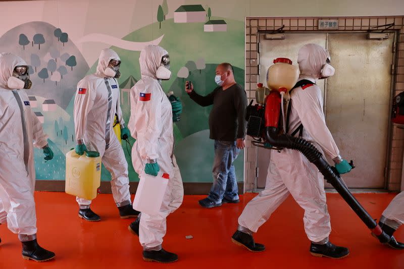 Soldiers prepare to spray disinfectant at the Taoyuan General Hospital in Taoyuan