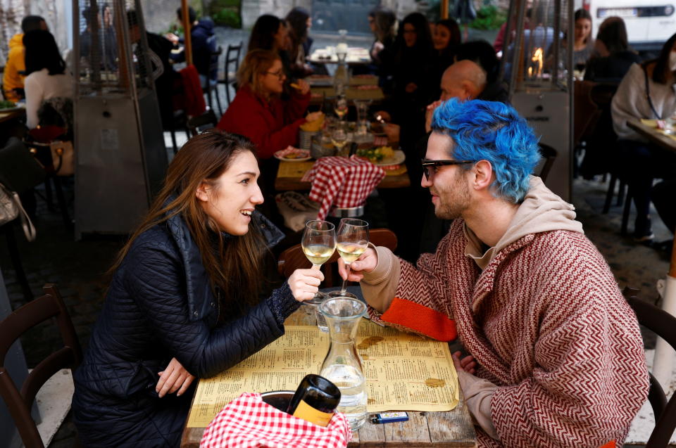 People make a toast as they sit at a restaurant in Trastevere after the coronavirus disease (COVID-19) restrictions were eased in Lazio region, Rome, Italy. (Reuters)