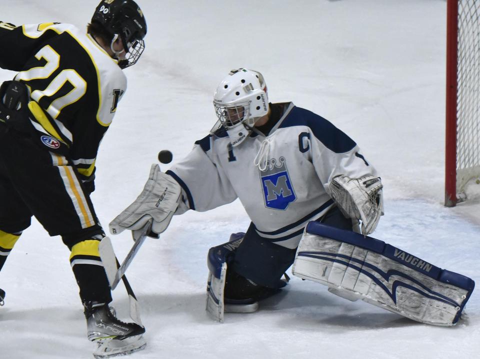 Mashpee/Monomoy goalie Dom Tsoukalas blocks a shot from Nauset's Jake Eldredge as Nauset and Mashpee-Monomoy High School teams met in Saturday afternoon boys hockey action at the Tony Kent Arena in Dennis.