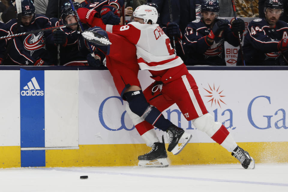 Detroit Red Wings' Ben Chiarot, right, checks Columbus Blue Jackets' Alexandre Texier during the second period of an NHL hockey game Monday, Oct. 16, 2023, in Columbus, Ohio. (AP Photo/Jay LaPrete)