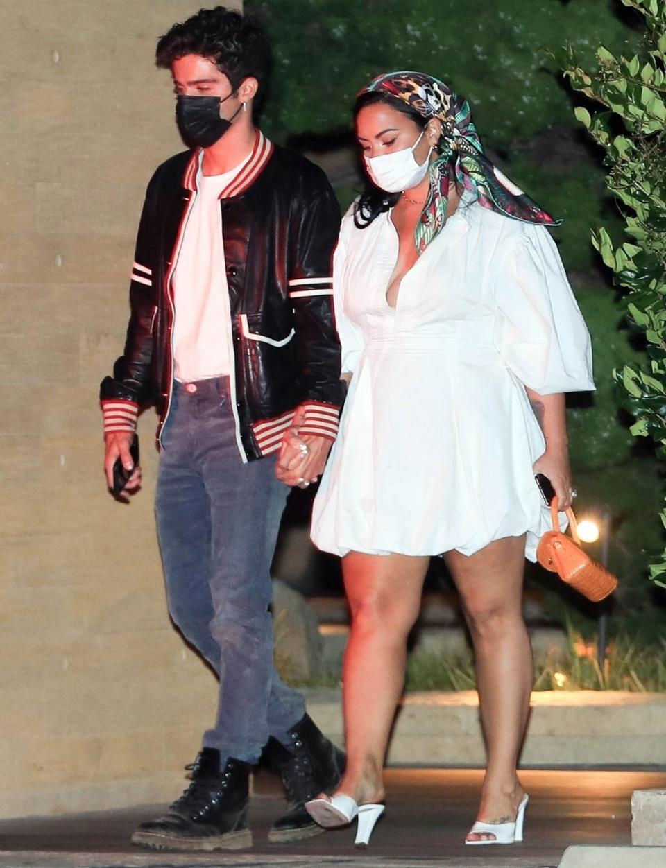 <p>Demi Lovato and fiancé Max Ehrich hold hands as they leave dinner at Nobu on Sunday. </p>